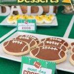 Football-shaped sugar cookies with icing on a plate, labeled “game day cookies,” with deviled eggs in the background on a football-themed table