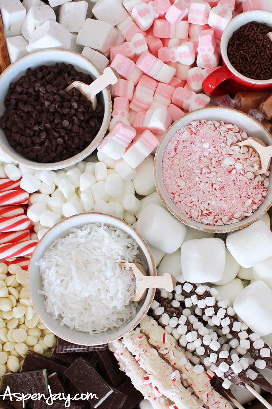 How to create a hot chocolate charcuterie board for your upcoming holiday party! Simple to make and such a great addition to your hot cocoa bar. Helpful tips and free printables included! #hotcocoabar #hotchocolatebar #hotcocoadessertboard
