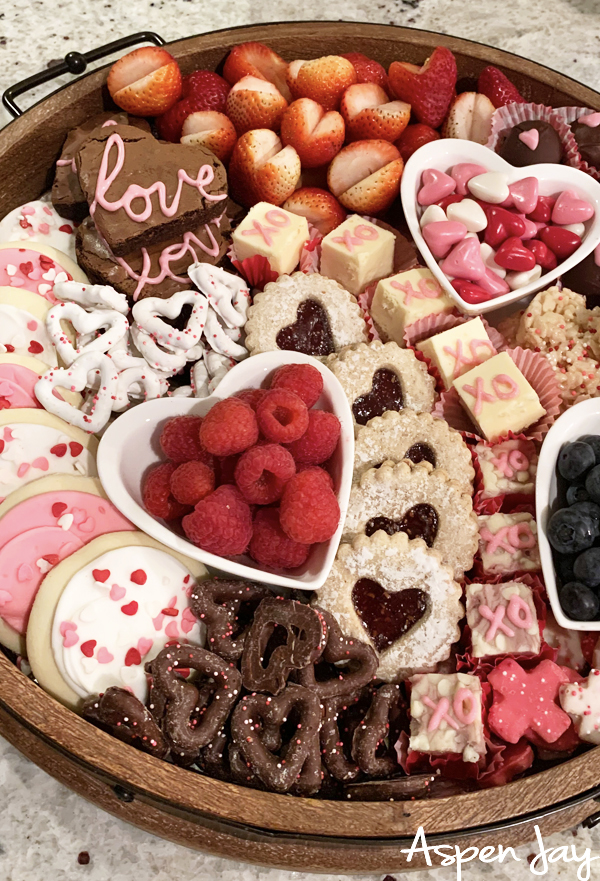 Impress your party guests by designing a Valentine's Charcuterie Board for February 14th to celebrate the day of love. These tips will help you confidently make your own. #valentinescharcuterieboard #valentinesdessertboard