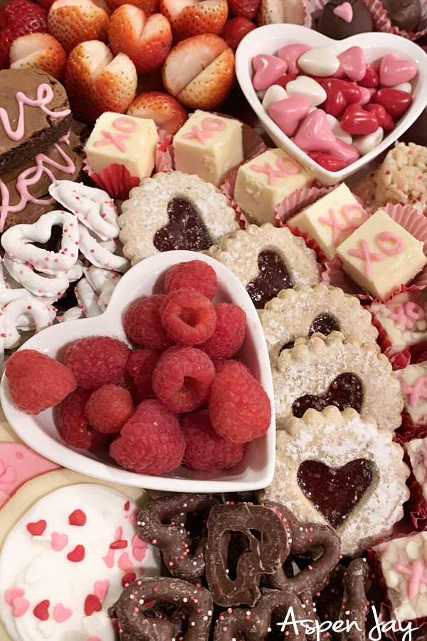 Impress your party guests by designing a Valentines Charcuterie Board for February 14th to celebrate the day of love. These tips will help you confidently make your own. #valentinescharcuterieboard #valentinesdessertboard