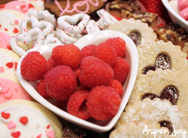 Impress your party guests by designing a Valentine's Charcuterie Board for February 14th to celebrate the day of love. These tips will help you confidently make your own. #valentinescharcuterieboard #valentinesdessertboard