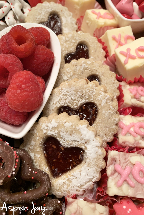 Impress your party guests by designing a Valentine's Charcuterie Board for February 14th to celebrate the day of love. These tips will help you confidently make your own. #valentinescharcuterieboard #valentinesdessertboard