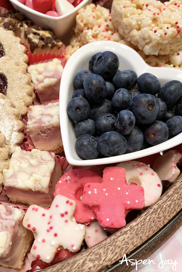 Impress your party guests by designing a Valentine's Charcuterie Board for February 14th to celebrate the day of love. These tips will help you confidently make your own. #valentinescharcuterieboard #valentinesdessertboard