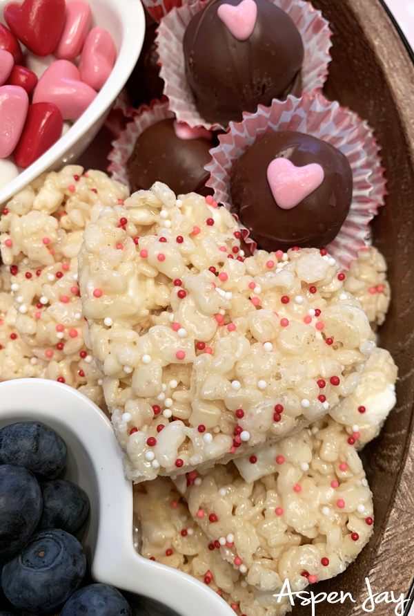 Impress your party guests by designing a Valentine's Charcuterie Board for February 14th to celebrate the day of love. These tips will help you confidently make your own. #valentinescharcuterieboard #valentinesdessertboard