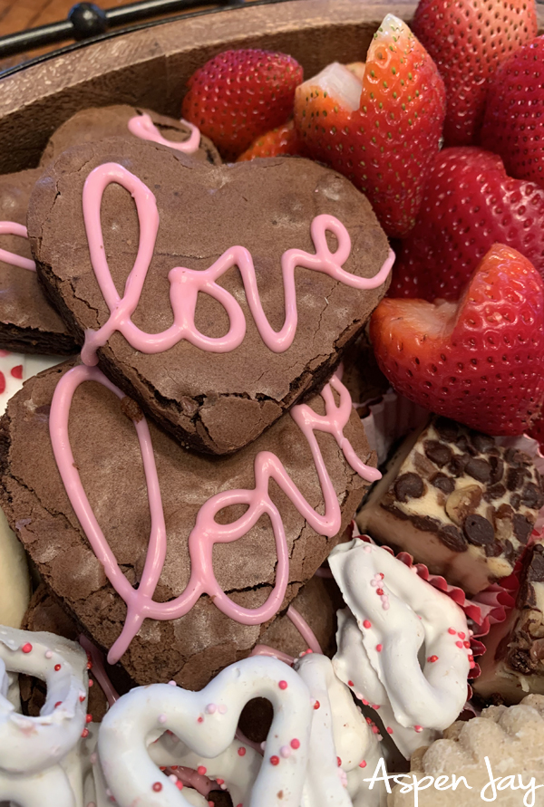 Impress your party guests by designing a Valentine's Charcuterie Board for February 14th to celebrate the day of love. These tips will help you confidently make your own. #valentinescharcuterieboard #valentinesdessertboard