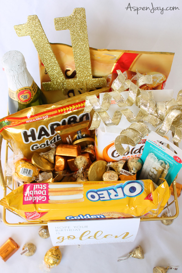 A gold themed basket of goodies and gifts would be the perfect gift for a golden birthday! It's simple to put together, can be scaled up or down to fit any budget, and is easily personalized to make for a perfect gift! Free Printables included! #goldenbirthday #goldengiftbasket #goldengift