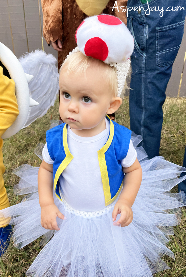 Make your toddler or little girl the star of Halloween with this DIY Toad costume! Learn how to craft a soft mushroom cap, cute vest, and girly tutu for a fun Super Mario-inspired look. 