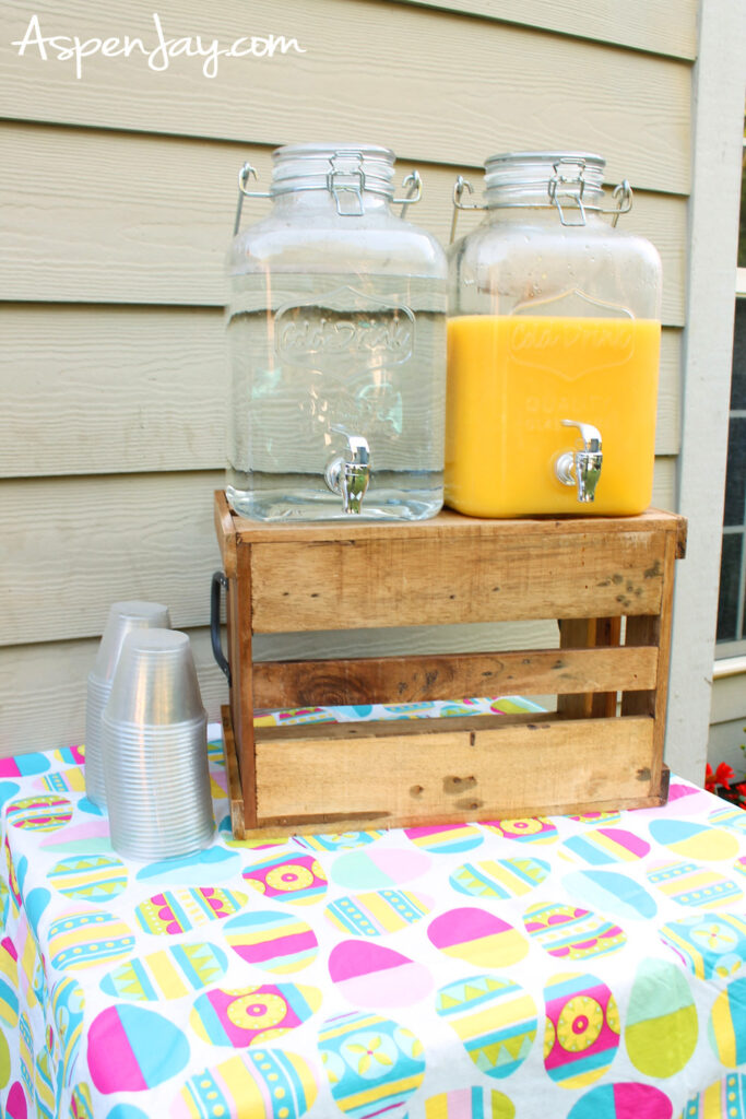 Easter drink station with orange juice and water dispensers on table