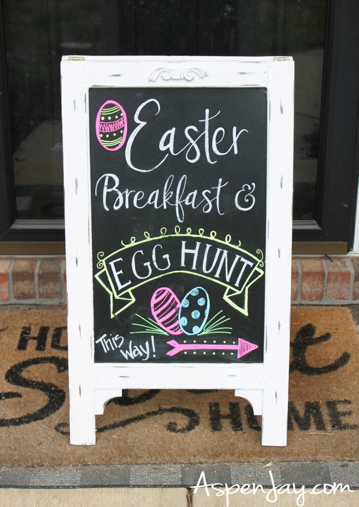 Easter breakfast and egg hunt welcome sign with chalkboard and arrow pointing to backyard