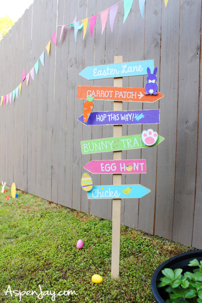 colorful Easter signpost with directions like egg hunt and bunny trail in backyard