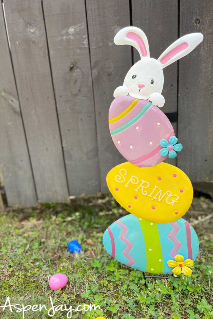 Easter bunny yard decoration sign with pastel eggs and spring theme in backyard