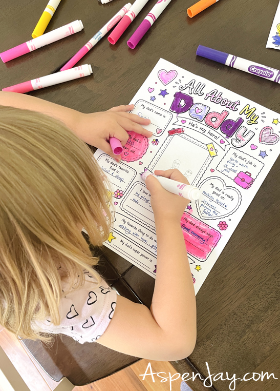 Child completing a free All About My Dad printable keepsake activity for Father's Day.