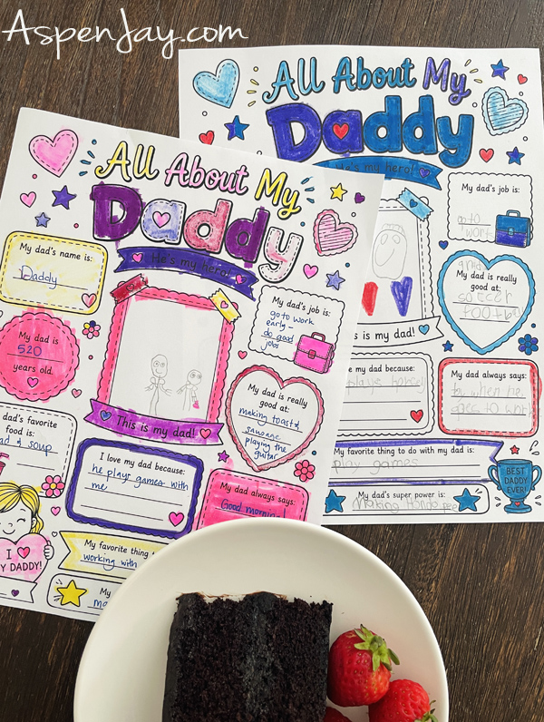 Completed All About My Daddy Father's Day printable questionnaires colored by children and displayed beside chocolate cake.