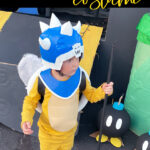 Child dressed in an epic handmade Koopa General Halloween costume outdoors